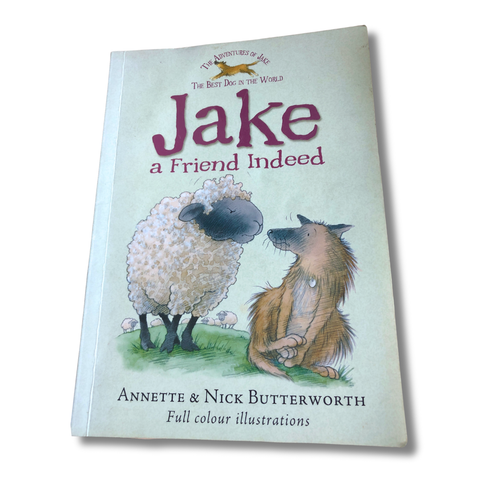Book cover of 'Jake a Friend Indeed' with illustrations of a dog and sheep on a light blue background.