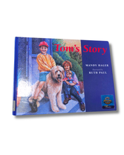 Load image into Gallery viewer, Book titled 'Tom's Story' with a cover featuring a boy, dog, and family on a blue background. Available to purchase in New Zealand