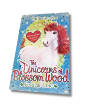 Load image into Gallery viewer, Book cover of 'The Unicorns of Blossom Wood: Festival Time' with a unicorn illustration on a blue background. Available to purchase in New Zealand