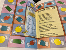 Load image into Gallery viewer, Open book with a game instructions page titled &#39;Sweet factory&#39; featuring candy-themed illustrations.