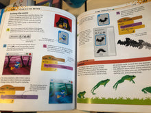 Load image into Gallery viewer, Open book with educational content on a theme of a dark room with a cat and a frog.
