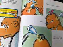 Load image into Gallery viewer, Illustrated book pages showing a bear character with medical tools and a thermometer.