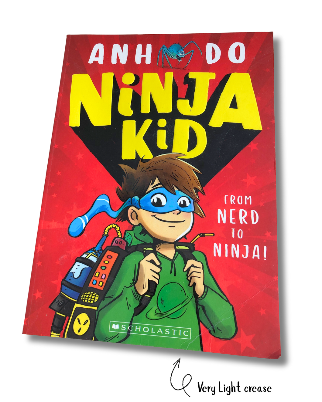 Book cover of 'Ninja Kid' with a child in a green outfit and blue mask on a red background.